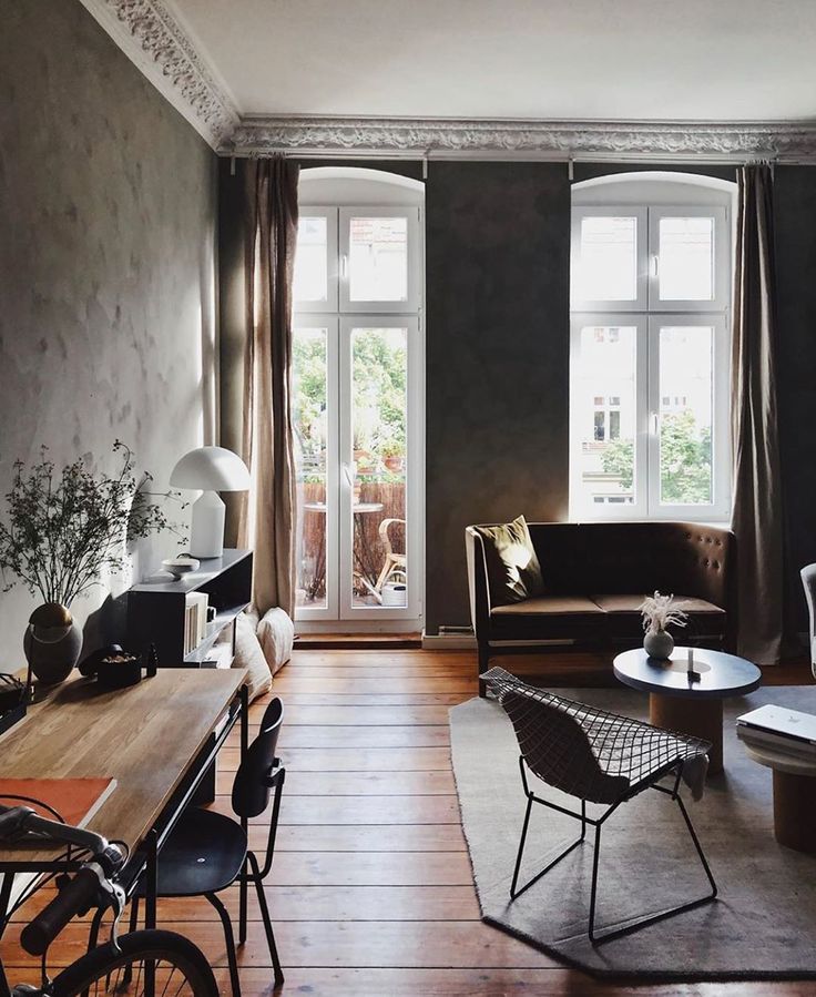 an image of a living room setting with furniture and decor on the walls in black and white