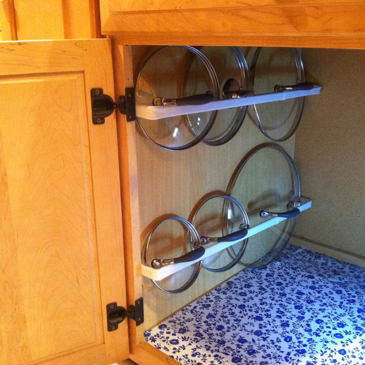 a kitchen with wooden cabinets and blue tile flooring on the bottom half of the cabinet