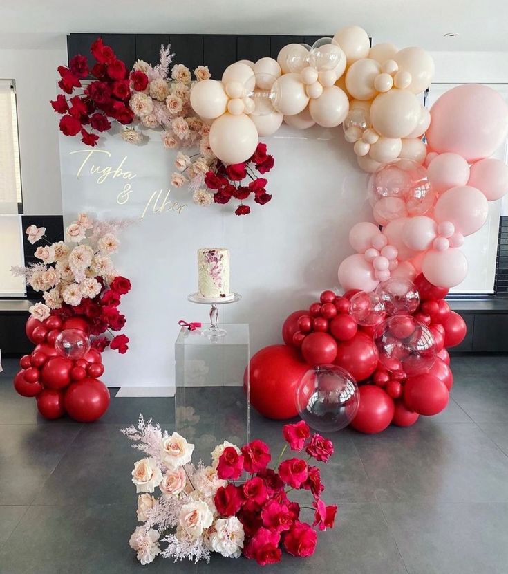 balloons and flowers are arranged on the floor