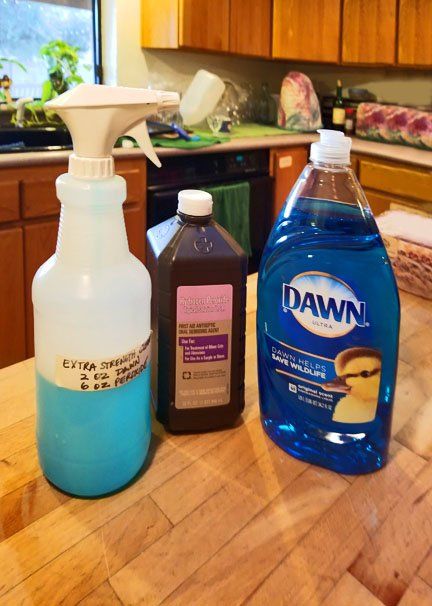 three different types of cleaning products on a kitchen counter