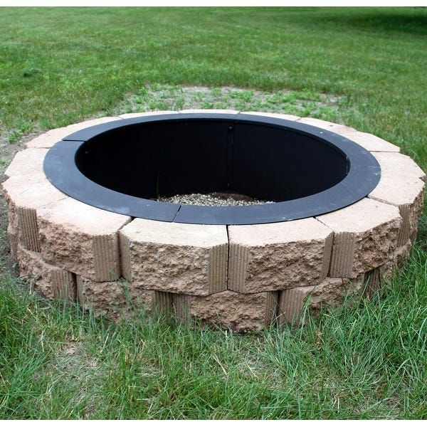 an outdoor fire pit in the grass