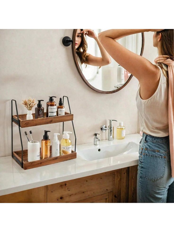 a woman standing in front of a bathroom sink