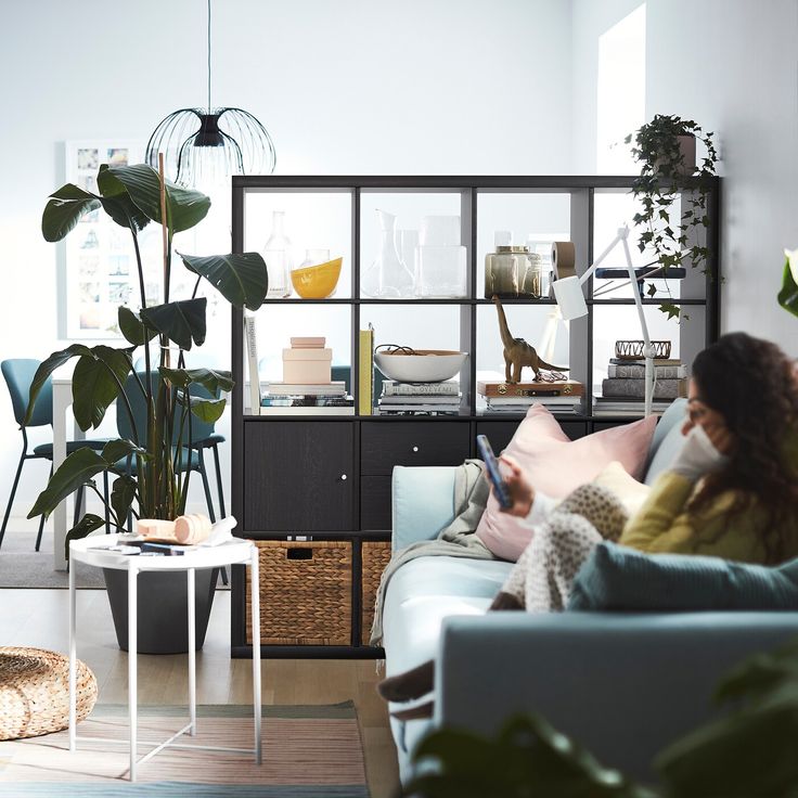 a woman sitting on a couch looking at her cell phone