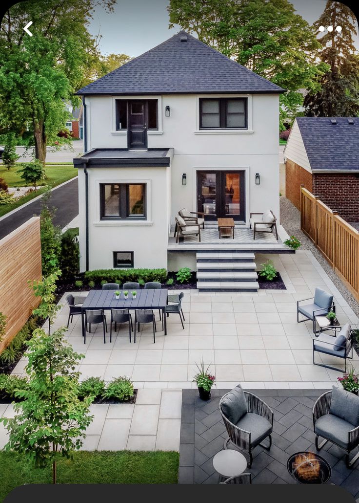 an aerial view of a house with patio furniture