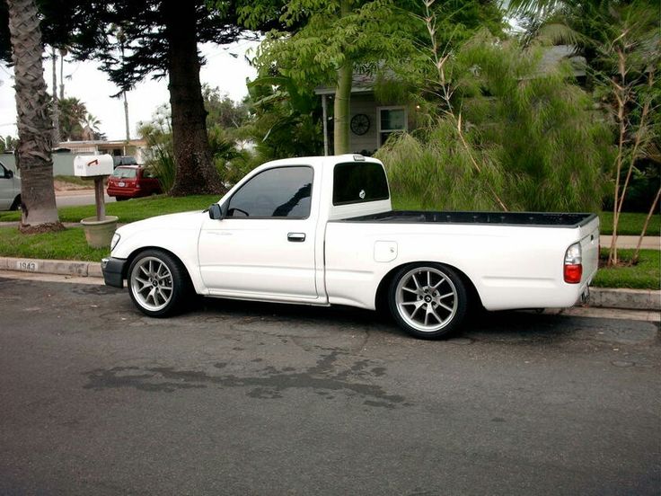 a white pick up truck parked on the side of the road