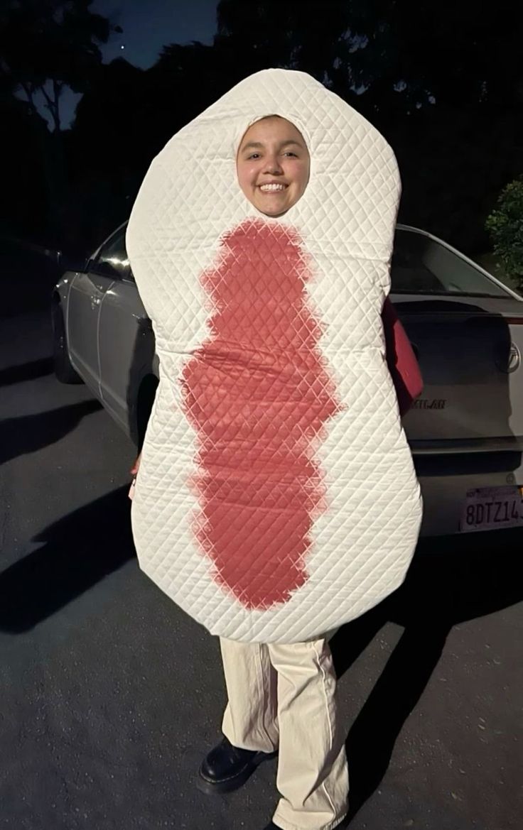 a woman is holding up a large piece of fabric that looks like a lipstick stain