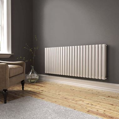 a living room with a couch, chair and radiator