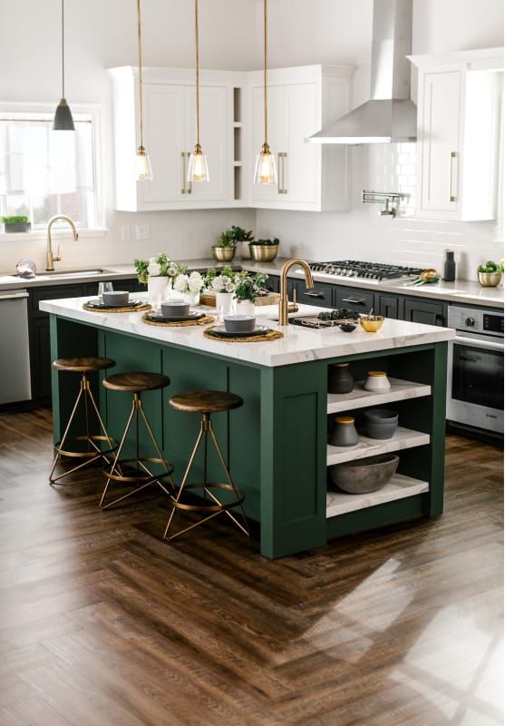 a kitchen with green cabinets and white counter tops