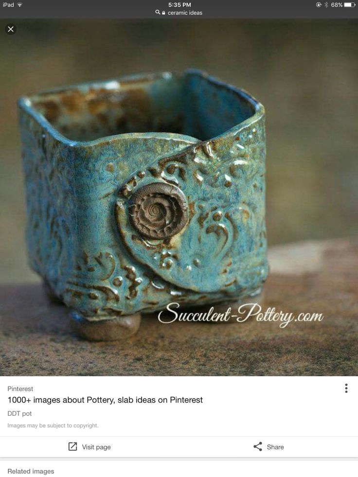 a small blue vase sitting on top of a table