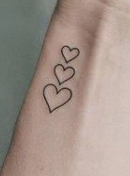 two hearts tattoo on the wrist