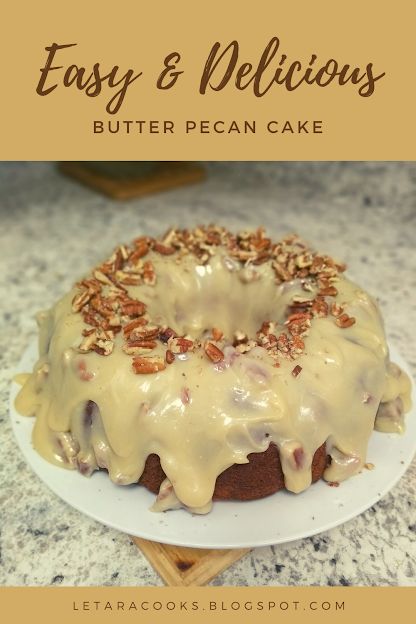 a bundt cake with icing and pecans on top sitting on a plate