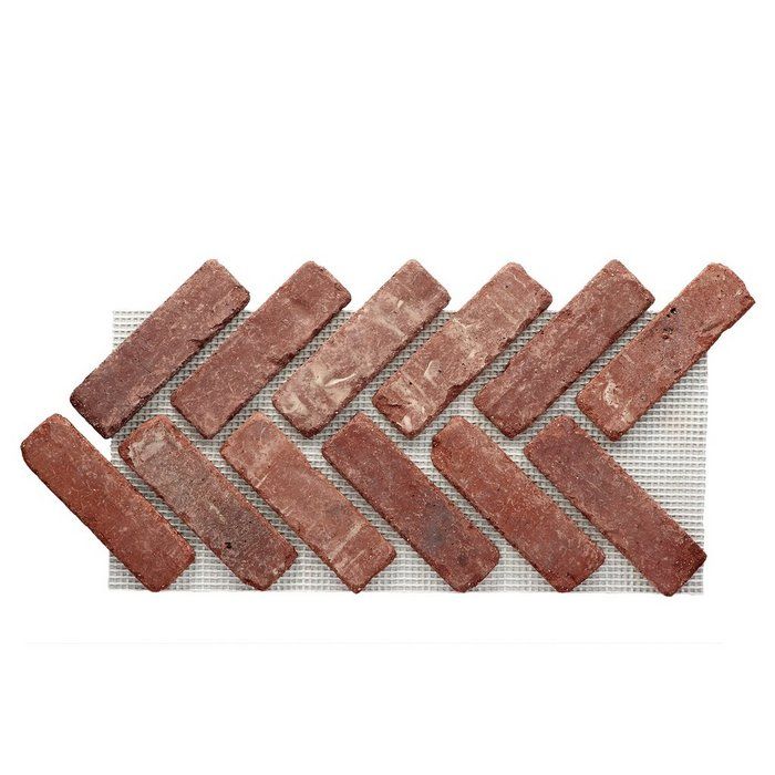 several pieces of red brick laid out on a white surface, with one piece missing from the