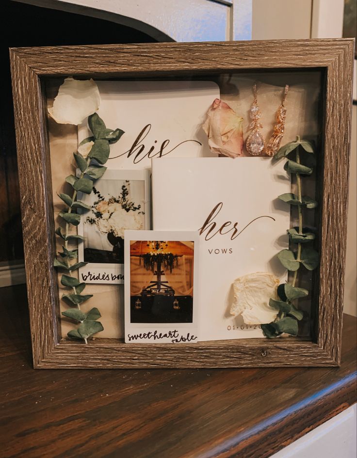 a wooden frame with some flowers and pictures