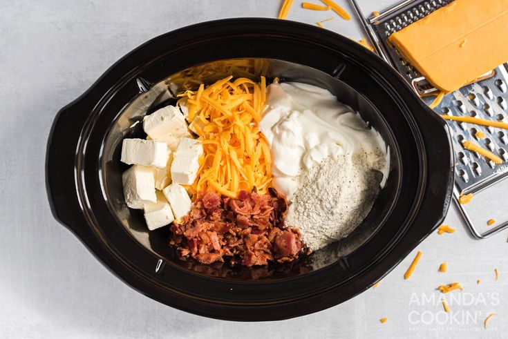 the ingredients for this slow cooker meal include cheese, ground beef, and shredded cheese