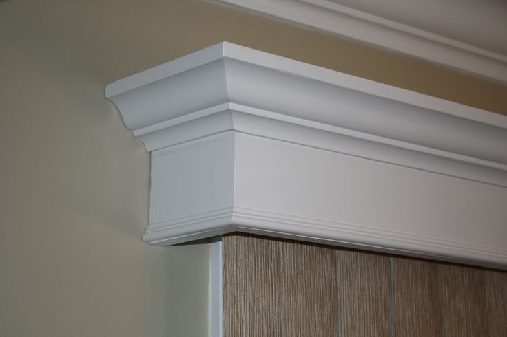 a close up view of the corner of a window sill with wood paneling