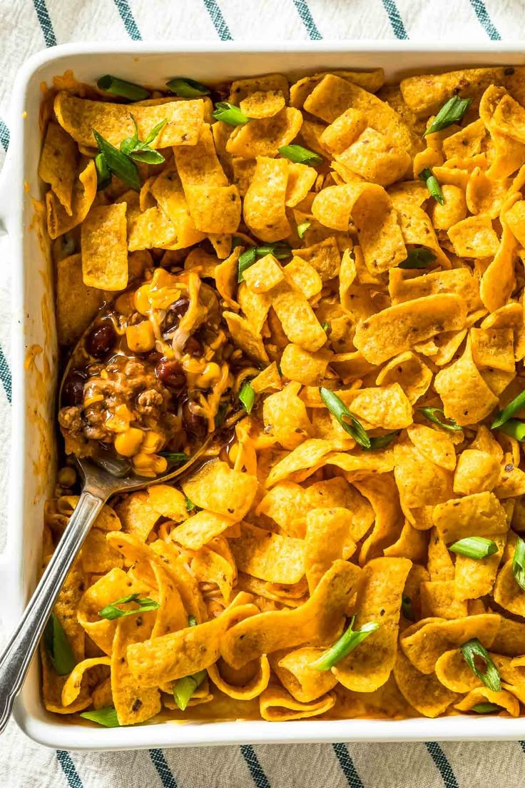 a casserole dish filled with tortilla shells and cheese