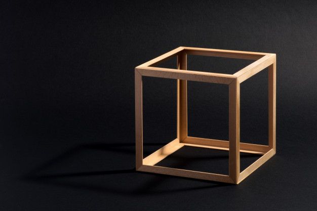 a square wooden object on a black background