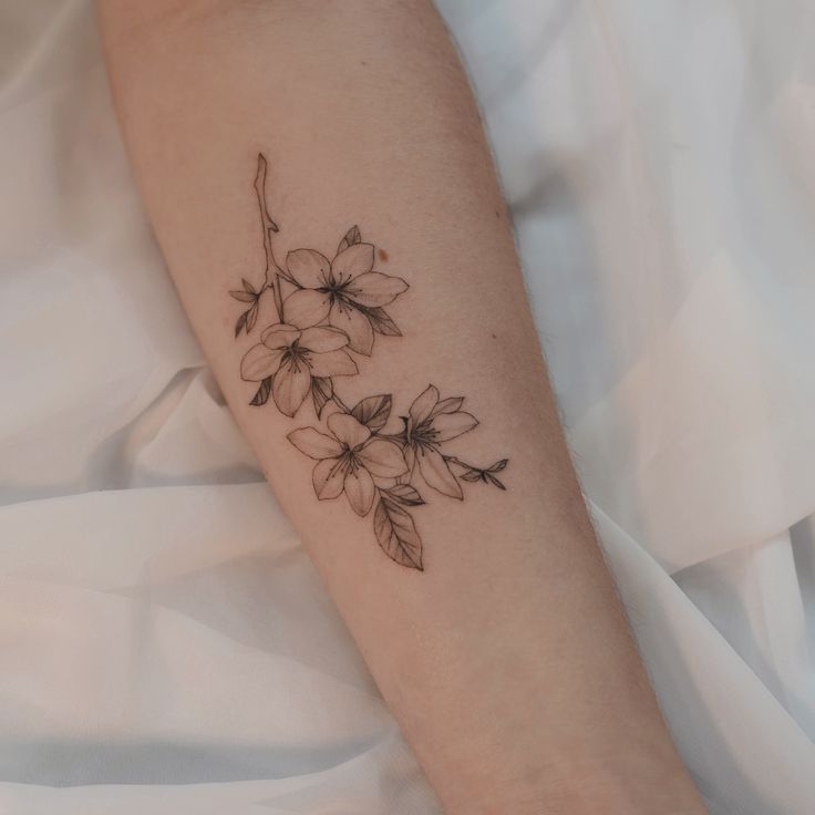 a woman's arm with flowers on it