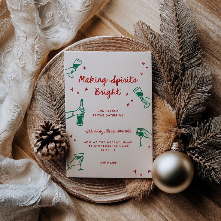 a christmas card sitting on top of a glass plate next to pine cones and ornaments