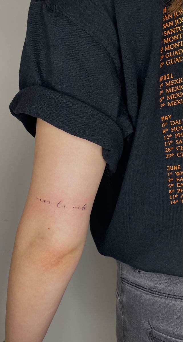 a woman's arm with the word love written in cursive writing on it