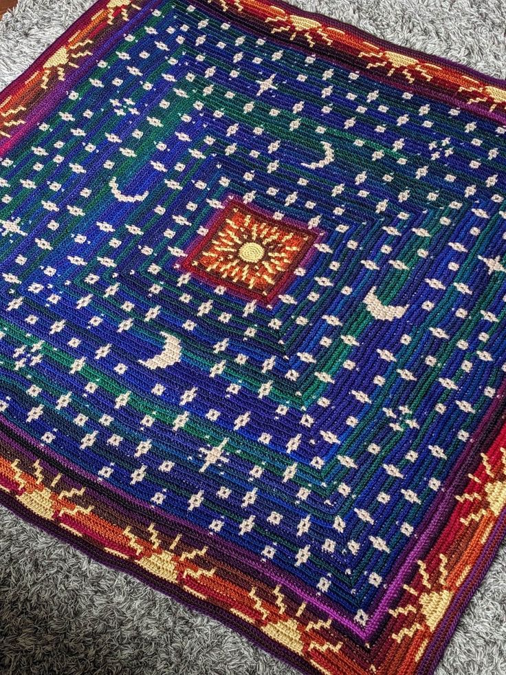 an old rug is laying on the floor with it's colorful design and colors