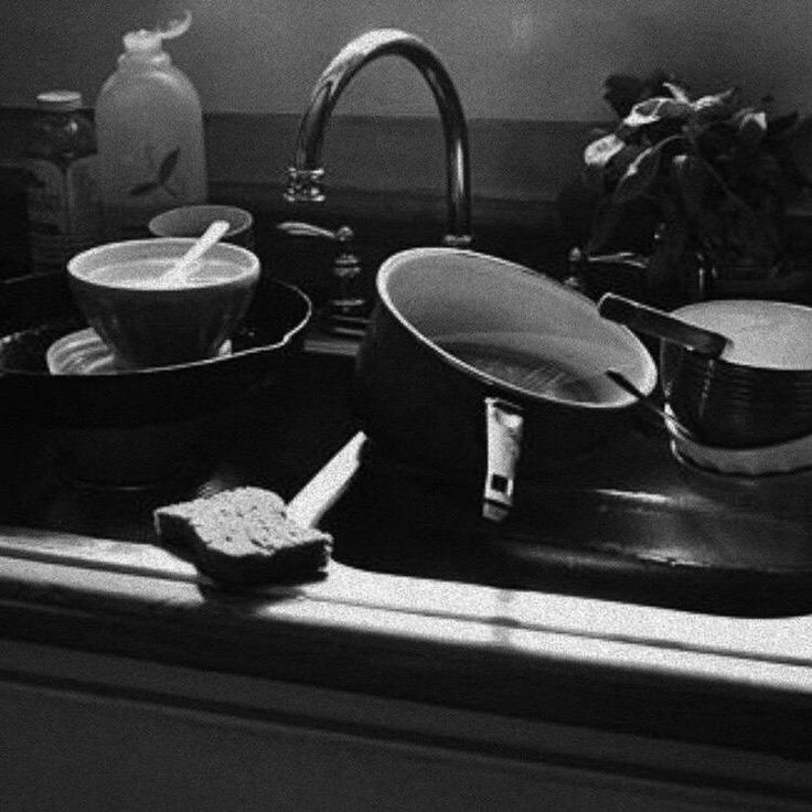 pots and pans are sitting on the kitchen sink