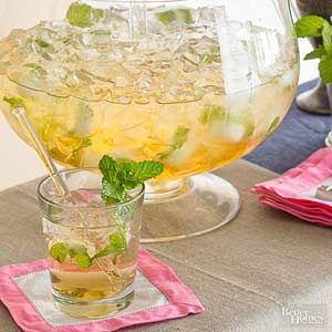 a pitcher filled with lemonade and mint on top of a table