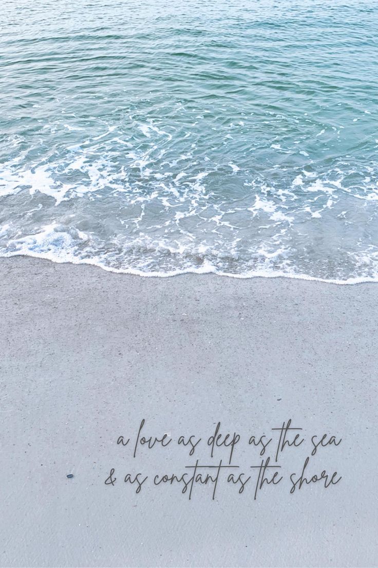 a message written on the sand next to the ocean with waves coming in from the shore