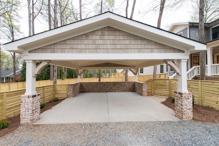 a covered parking lot in front of a house