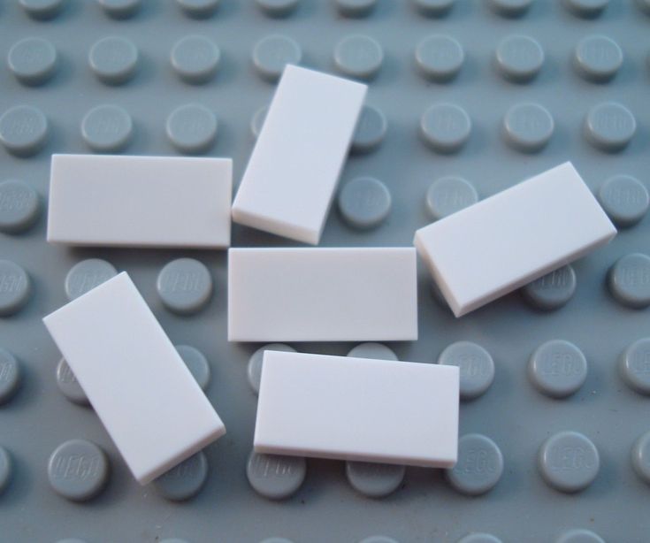 white legos are arranged on top of each other in the shape of rectangles