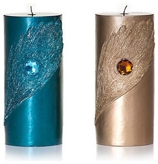 three candles with different designs on them, one is blue and the other is silver