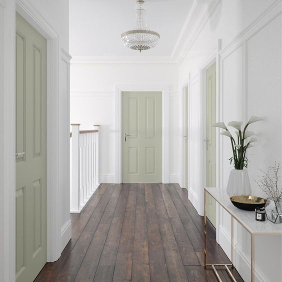 an empty hallway with white walls and wood floors