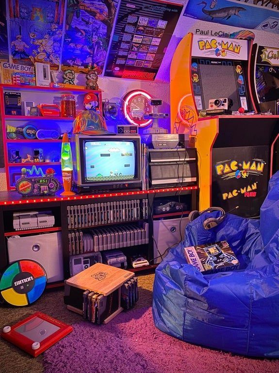 a room filled with lots of toys and games on top of carpeted flooring