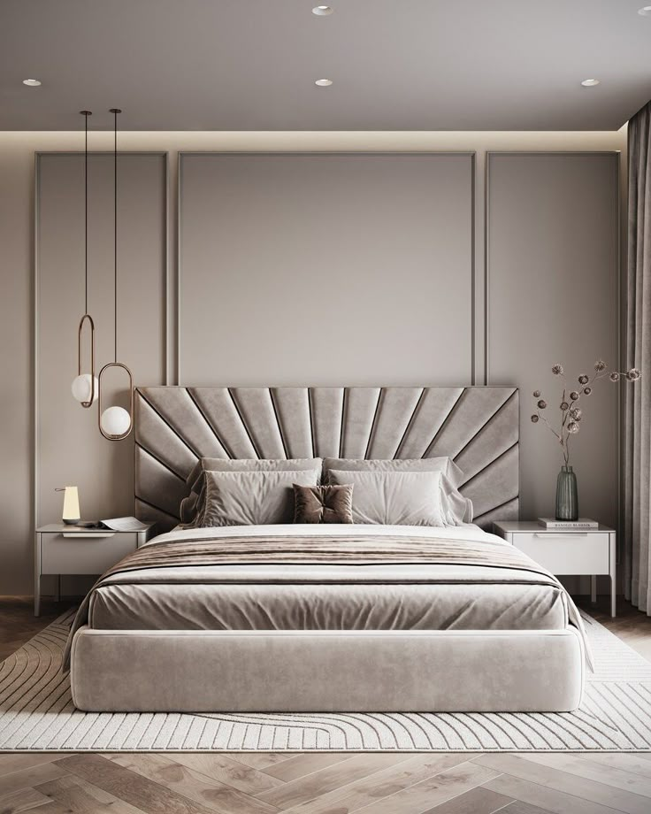 a large bed sitting in the middle of a bedroom next to a wall mounted lamp