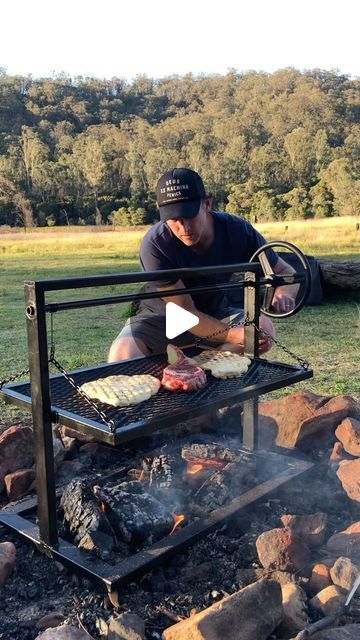 a man grilling food over an open fire