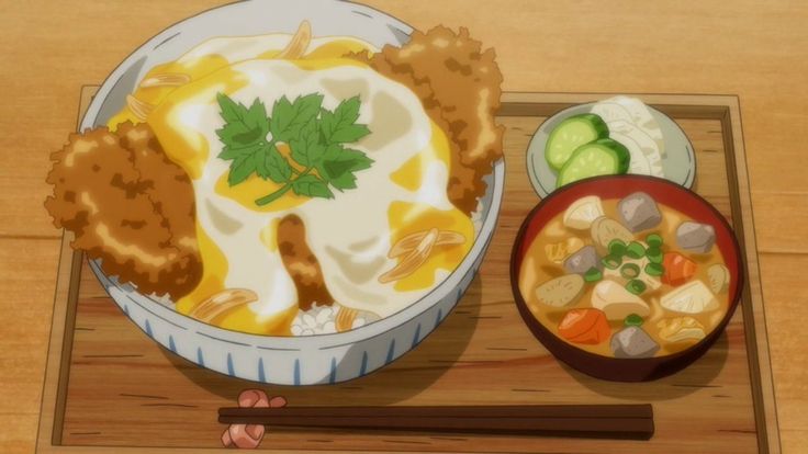 there is a bowl of food and a bowl of soup on the table