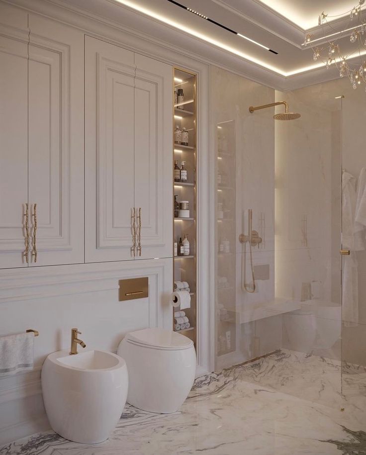 a white bathroom with two toilets and a walk in shower