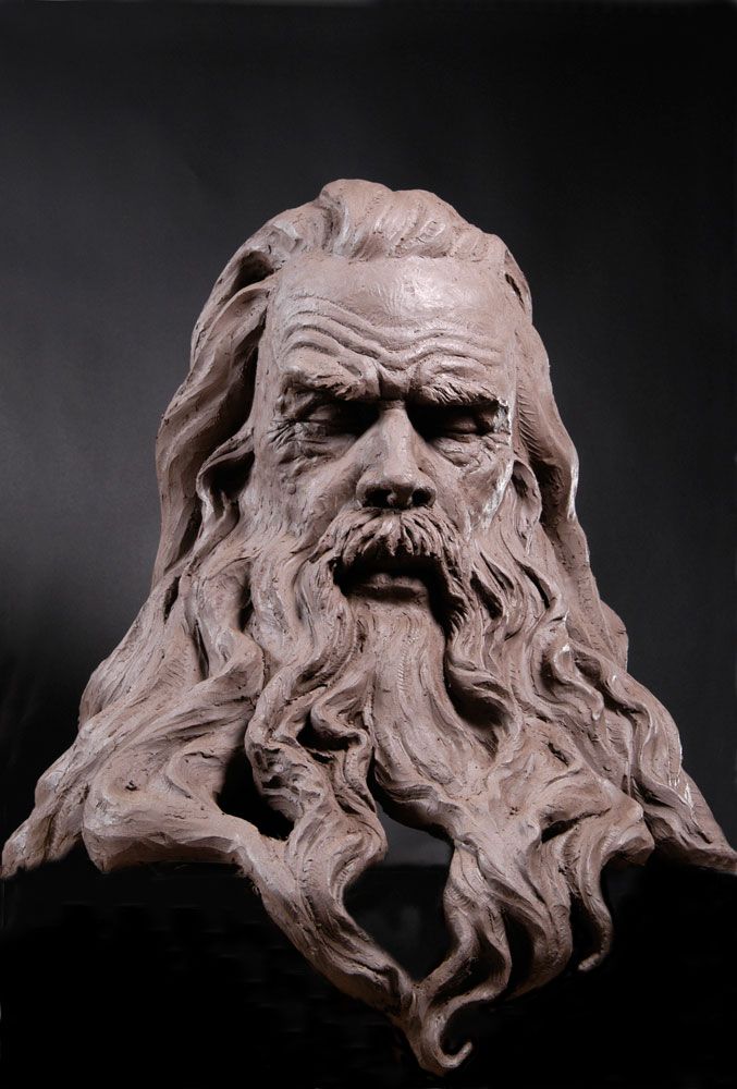 a statue of an old man with long hair and beard