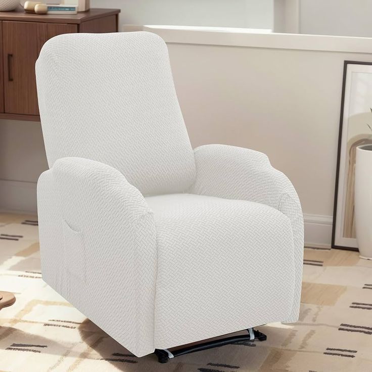 a white recliner chair sitting on top of a rug