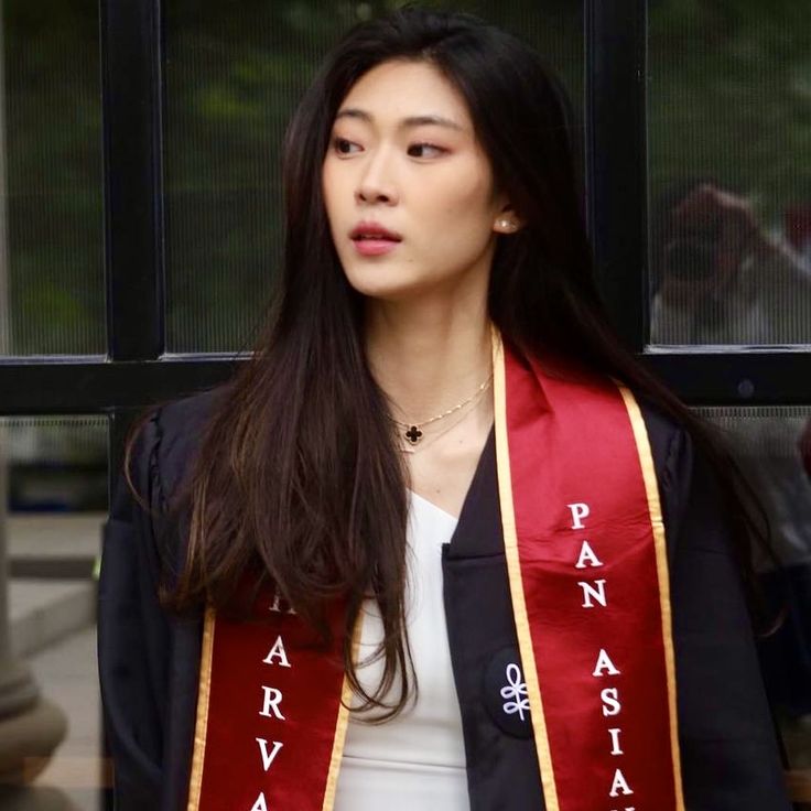 a woman wearing a red and gold sash