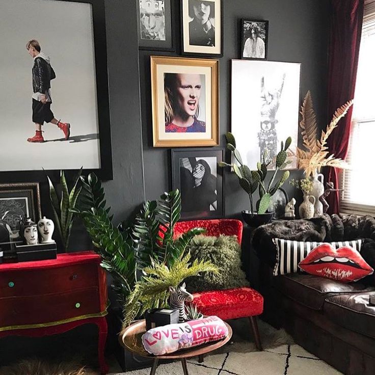 a living room filled with furniture and pictures on the wall