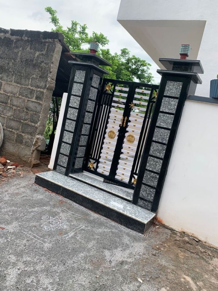 an iron gate with white and black decorations on it