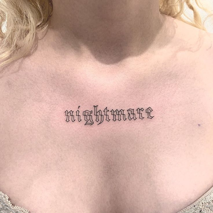 a woman's chest with the word nightmares written on it in cursive font