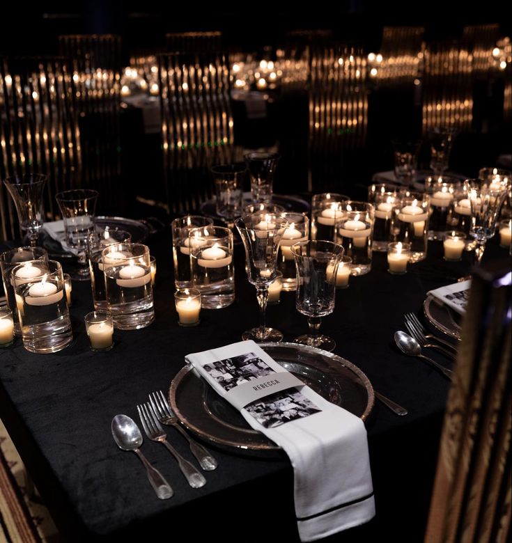 a table with candles, plates and silverware on it