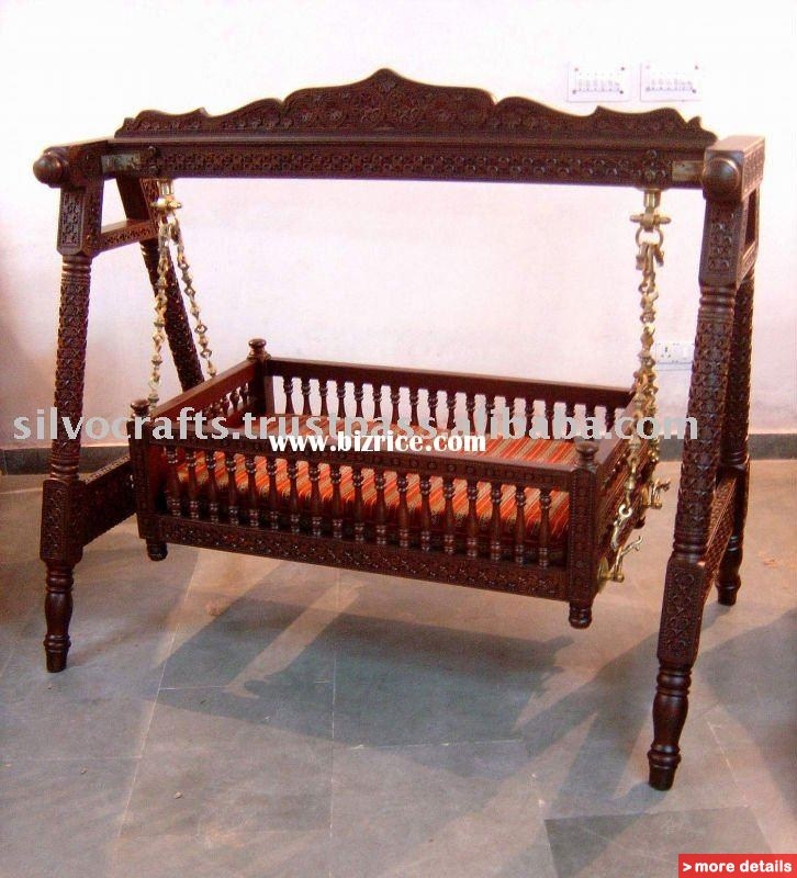 an ornate wooden swing with chains hanging from it's sides and seats on each side