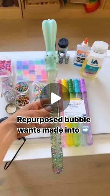 someone is making bubble wands out of plastic bottles and other crafting supplies on a table