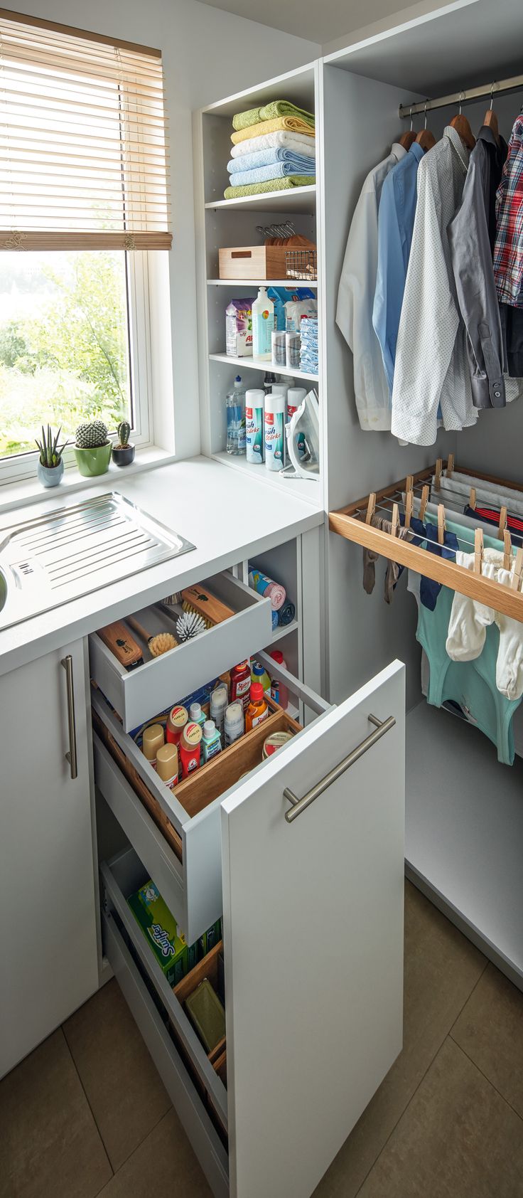 an organized kitchen with white cabinets and open drawers in the cupboards that are filled with items