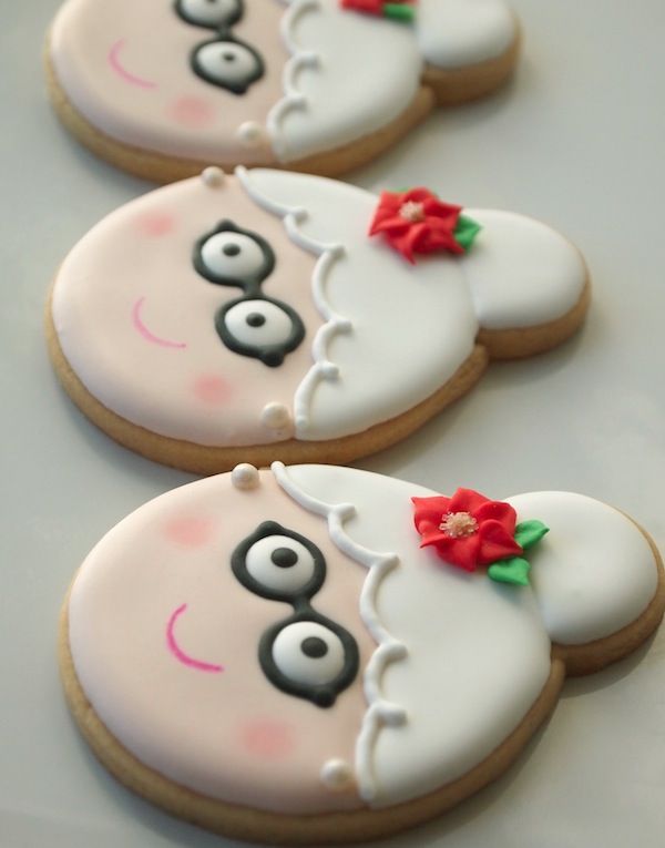 three decorated cookies sitting on top of a table