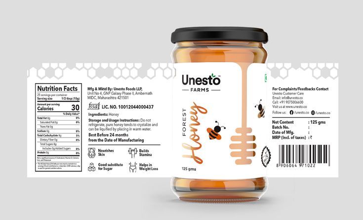 a jar of honey sitting on top of a table next to a label that says unesto