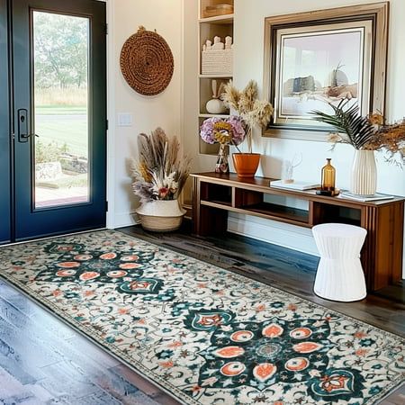 a room with a rug, vases and pictures on the wall next to it